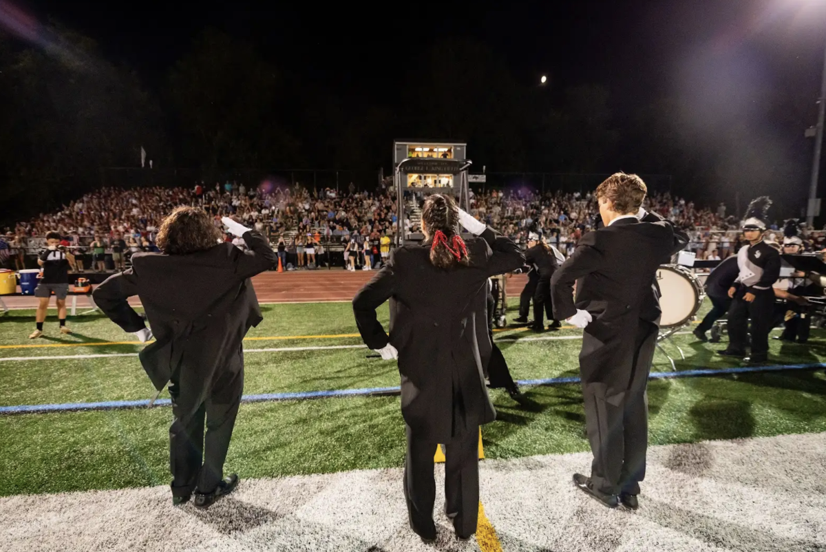 The Haven Marching Band drum majors salute to the crowd at the home opener against Radnor on September 13 before the start of the halftime show.